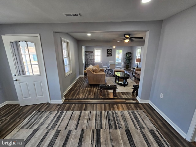 interior space with ceiling fan and dark hardwood / wood-style flooring