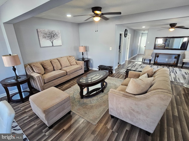 living room with dark wood-type flooring and ceiling fan