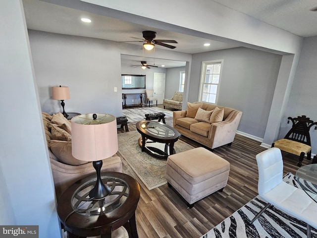 living room with dark wood-type flooring and ceiling fan