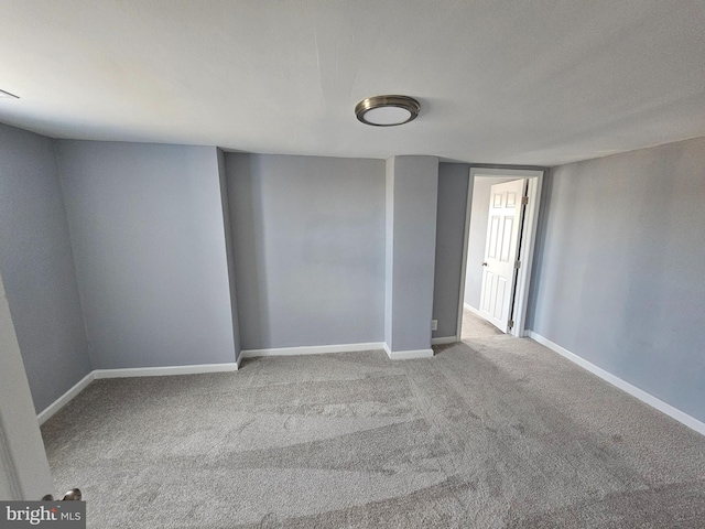 spare room featuring light colored carpet