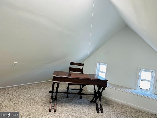 office space featuring lofted ceiling, carpet, and a healthy amount of sunlight