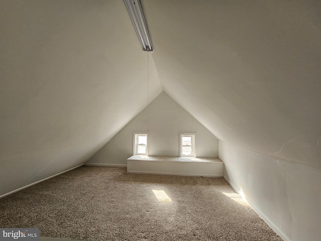 bonus room featuring lofted ceiling and carpet floors