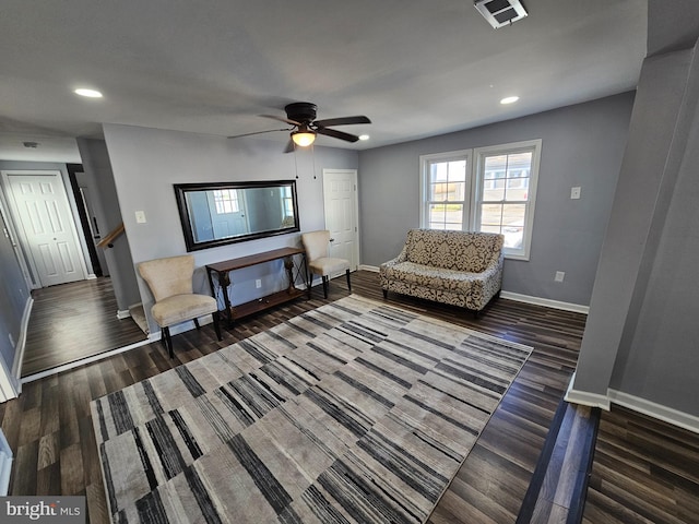 living area with dark hardwood / wood-style floors and ceiling fan