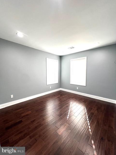 spare room featuring dark hardwood / wood-style floors