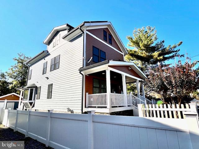 rear view of house with covered porch