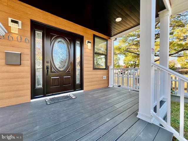 view of exterior entry with a porch