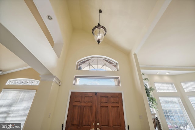 entrance foyer with high vaulted ceiling and decorative columns