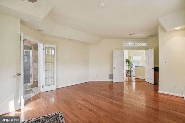 unfurnished room featuring hardwood / wood-style flooring and a healthy amount of sunlight