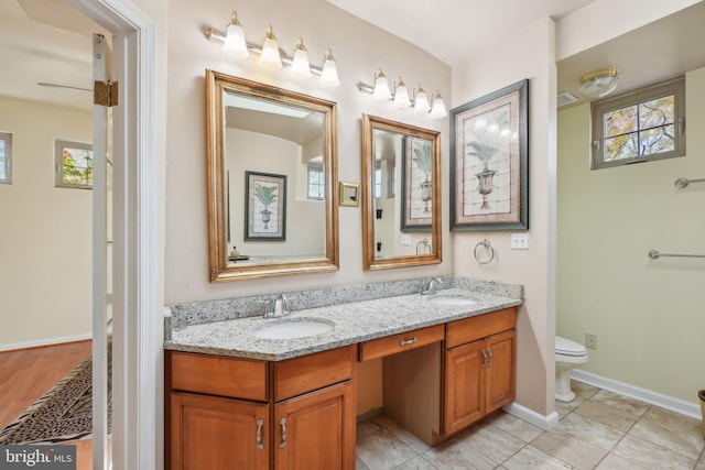 bathroom with vanity, tile patterned flooring, plenty of natural light, and toilet