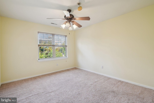 carpeted empty room featuring ceiling fan