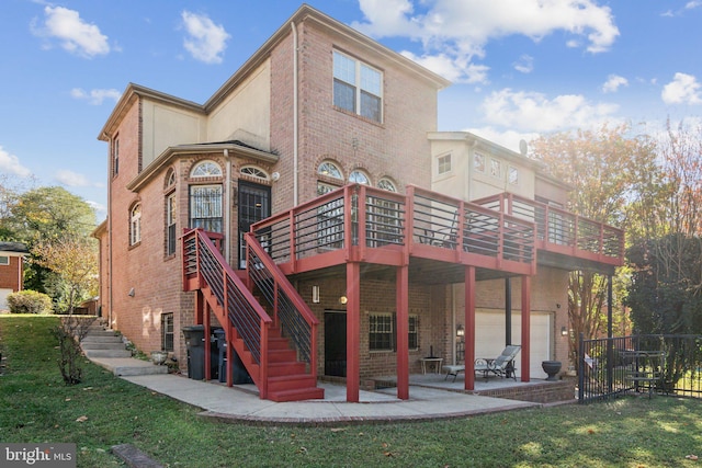 back of property featuring a garage, a wooden deck, a yard, and a patio area