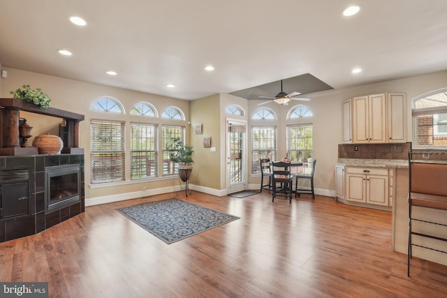 interior space with a wealth of natural light, ceiling fan, and light wood-type flooring