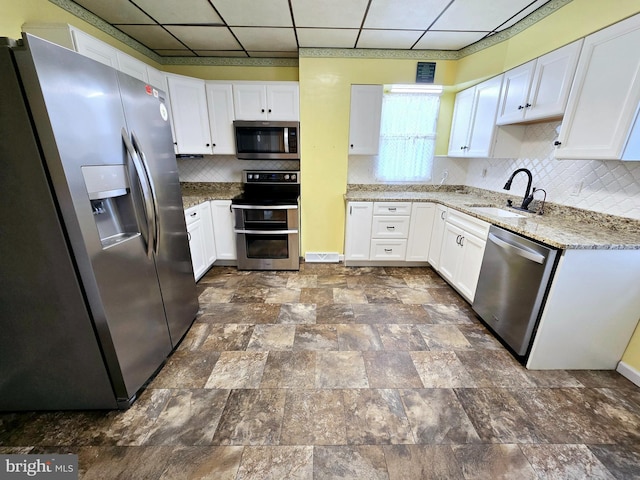 32 S F St, Keyser, WV 26726 - kitchen with stainless steel appliances, a sink, a paneled ceiling, and white cabinets