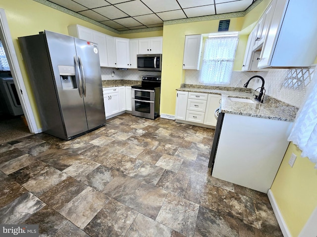 32 S F St, Keyser, WV 26726 - kitchen with stainless steel appliances, a sink, decorative backsplash, light stone countertops, and white cabinetry