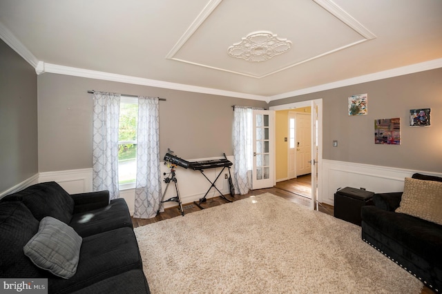 living room with crown molding and hardwood / wood-style flooring