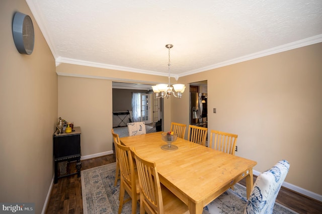 dining area featuring ornamental molding, an inviting chandelier, dark hardwood / wood-style floors, and a textured ceiling