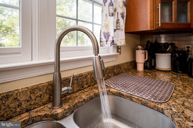 room details featuring decorative backsplash and sink