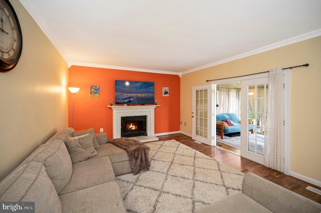 living room with french doors, ornamental molding, and hardwood / wood-style flooring