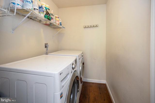 laundry area featuring dark wood-type flooring and independent washer and dryer