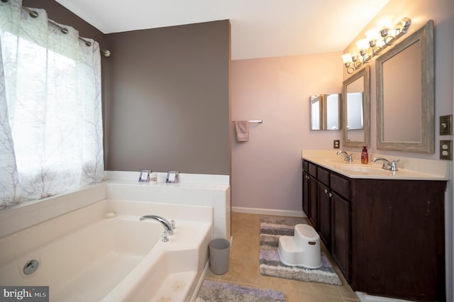 bathroom featuring a bathing tub, vanity, and tile patterned flooring