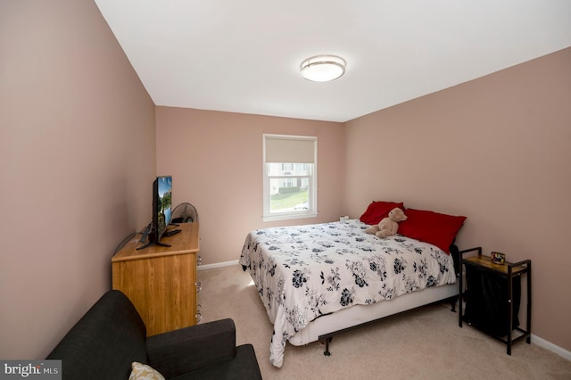 bedroom featuring light colored carpet