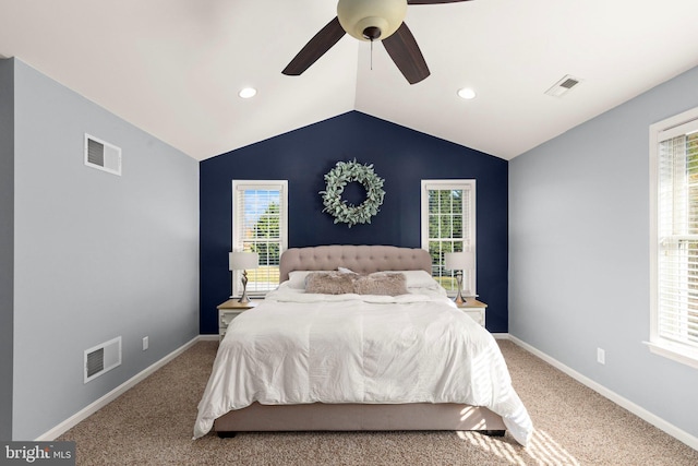 carpeted bedroom with ceiling fan and lofted ceiling