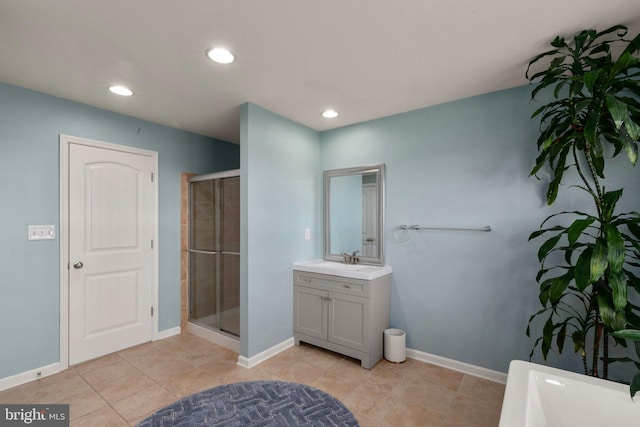 bathroom with tile patterned floors, a shower with door, and vanity