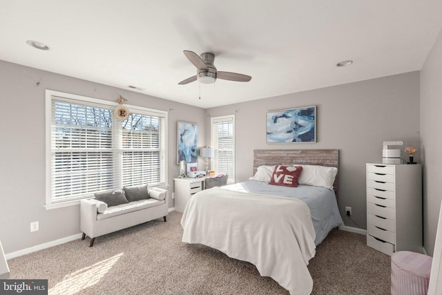 carpeted bedroom with ceiling fan and multiple windows