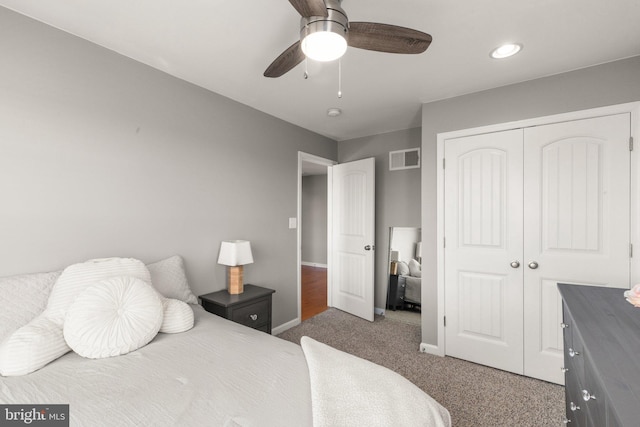 carpeted bedroom featuring a closet and ceiling fan