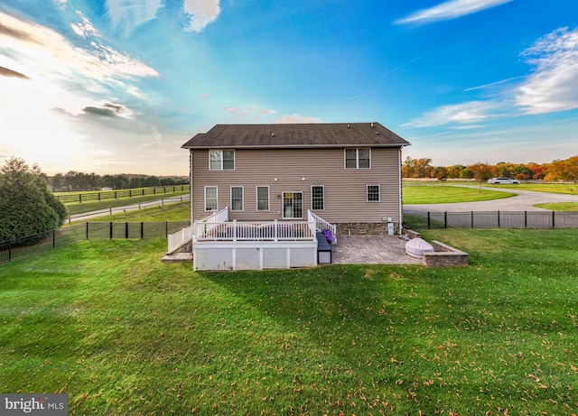 back of house with a yard, a patio, and a wooden deck