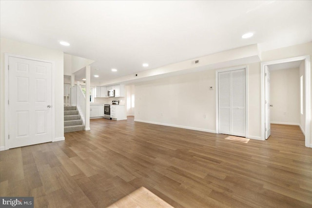 245 Knoxville Rd, Knoxville, MD 21758 - unfurnished living room with wood finished floors, baseboards, stairs, and recessed lighting