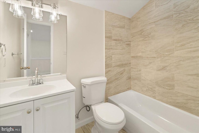 bathroom featuring vanity, toilet, and lofted ceiling