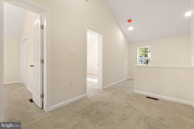 interior space featuring light colored carpet and high vaulted ceiling