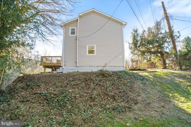 rear view of property featuring a deck