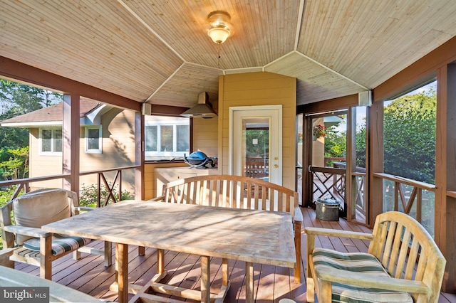 sunroom with lofted ceiling, wood ceiling, and plenty of natural light