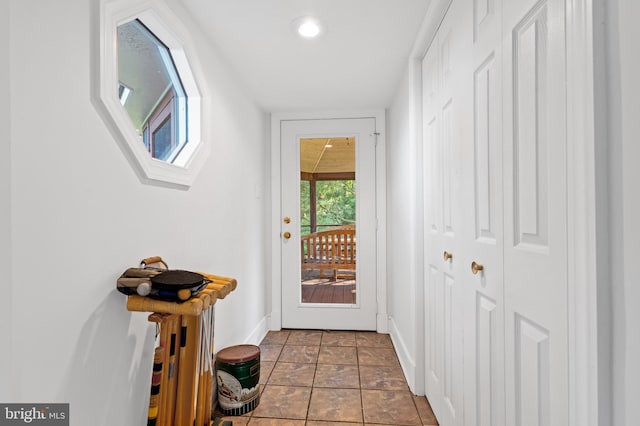 doorway featuring dark tile patterned floors