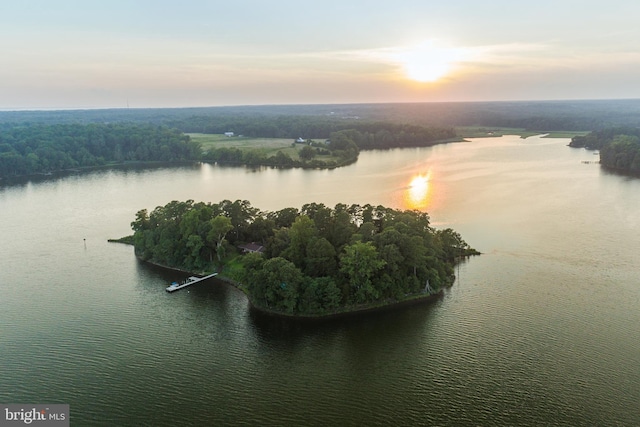 aerial view at dusk featuring a water view