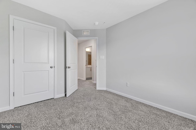 unfurnished bedroom featuring light colored carpet