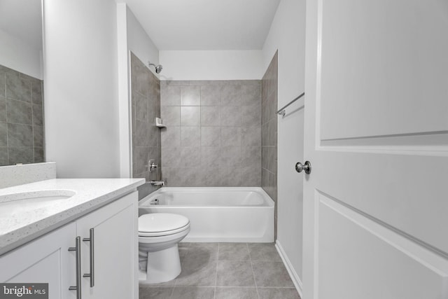 full bathroom featuring tiled shower / bath, vanity, toilet, and tile patterned floors