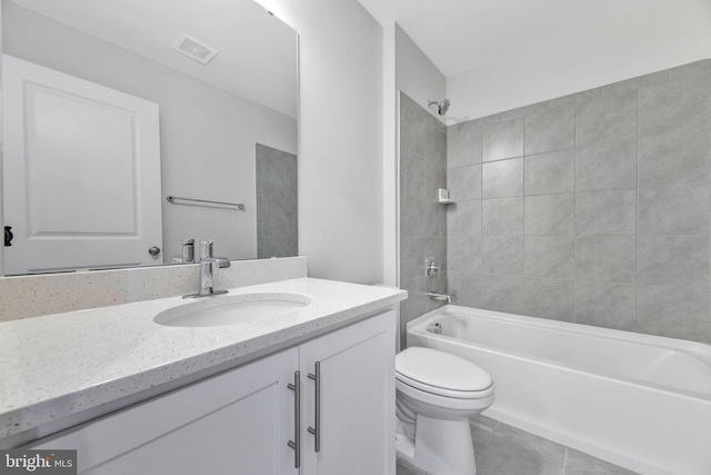 full bathroom with vanity, toilet, tile patterned flooring, and tiled shower / bath