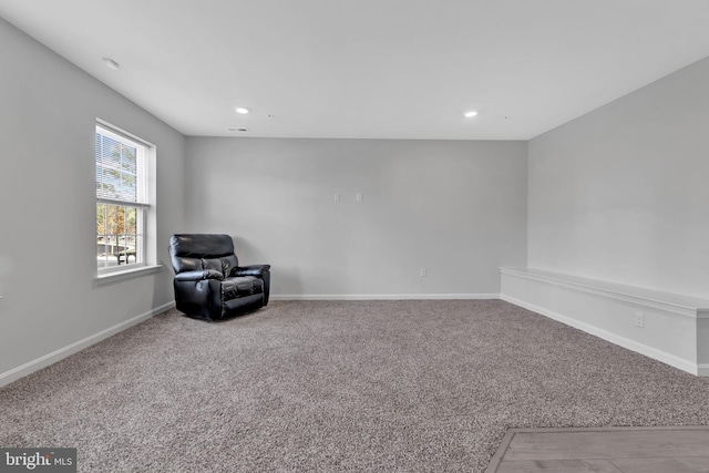 sitting room featuring light colored carpet