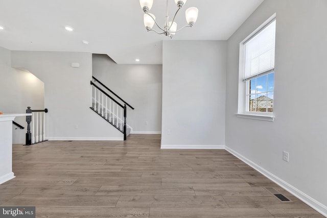 interior space featuring light hardwood / wood-style floors and a chandelier