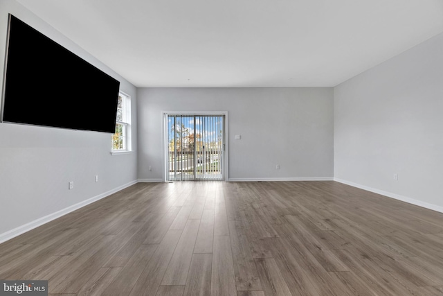 unfurnished room with hardwood / wood-style floors