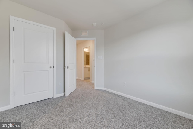 unfurnished bedroom with light carpet