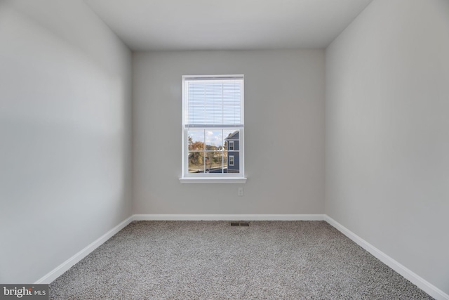 unfurnished room featuring carpet