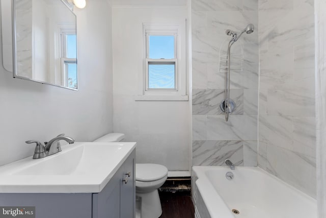 full bathroom with vanity, tiled shower / bath combo, and toilet