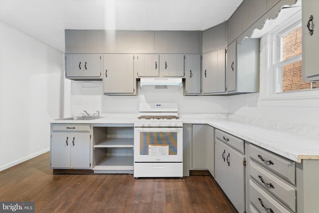 kitchen featuring gray cabinets, white range with gas stovetop, sink, and dark wood-type flooring