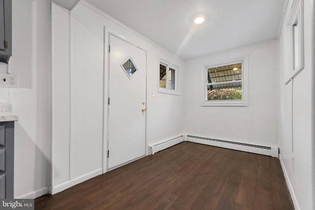 entrance foyer featuring ornamental molding, baseboard heating, and dark hardwood / wood-style floors