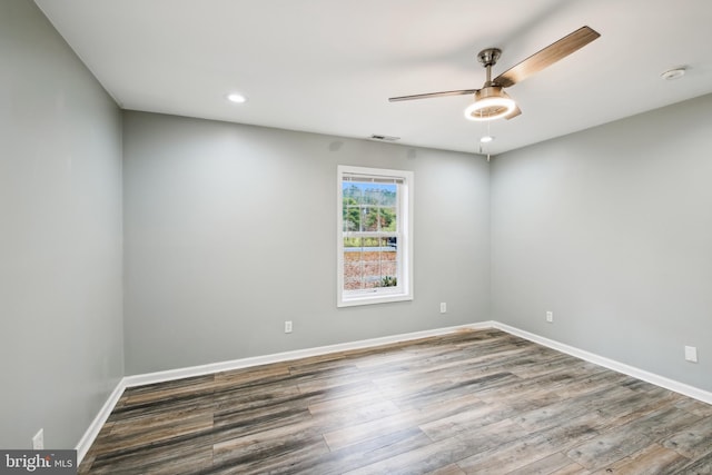 spare room with ceiling fan and wood-type flooring