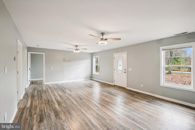 unfurnished living room featuring ceiling fan and wood-type flooring